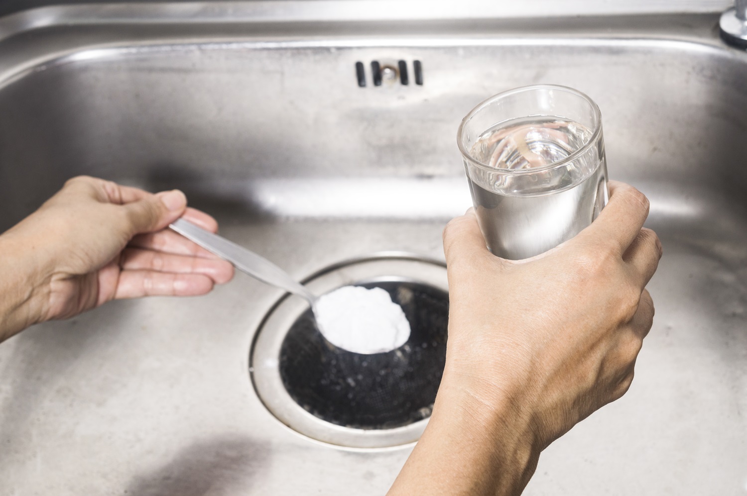 spoon of baking soda and a glass of vinegar into the drain of sink